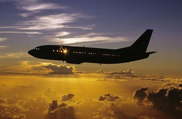 USA, Silhouette of airplane in sunset sky; Hawaii