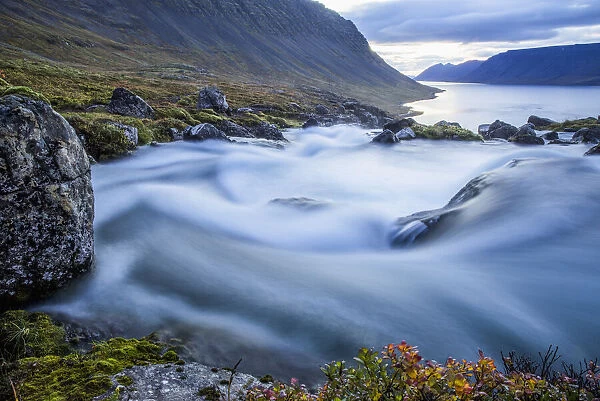 The Water From The Large Waterfall Called Dynjandi Flows By In This Long Exposure On Its Way To The Ocean; Westfjords, Iceland