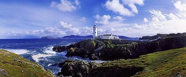 Waves Breaking On The Coast With A Light House In Background, Fanad Head, County Donegal, Republic Of Ireland