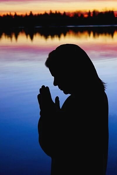 Woman Praying Near Water