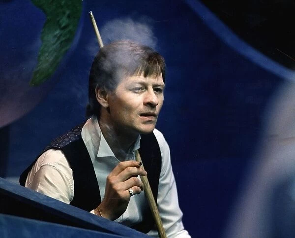 Alex Higgins snooker player alias Hurricane Higgins smoking cigarette during a match 1988