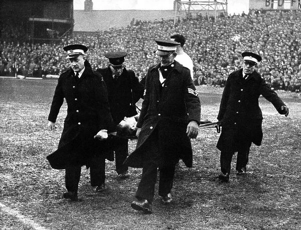 Brian Clough is carried from the field by the St John Ambulance Brigade after injuring