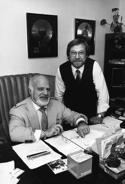 Don Arden Impresario with his son David in their office with Gold Records in the display