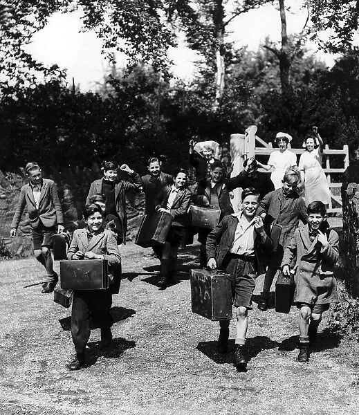 Evacuated children leave with their cases from their Leicestershire home as they head for
