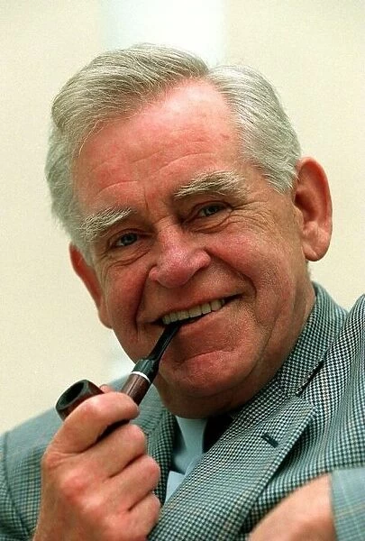 Magnus Magnusson TV Presenter Quiz Master smoking pipe at the launch of his new book Ive