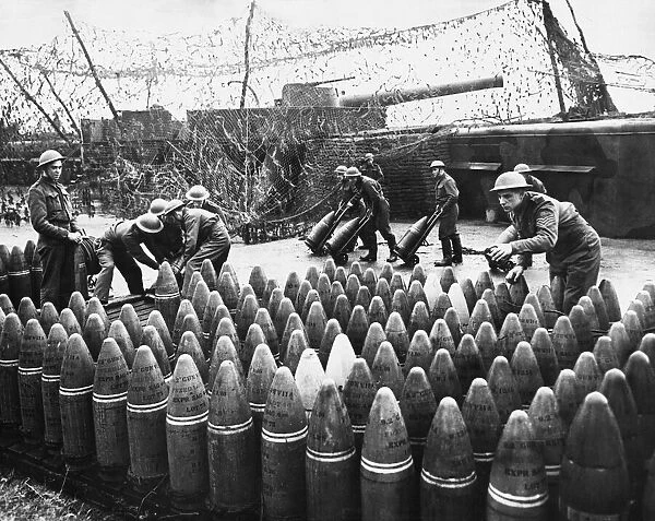 Soldiers stock pile artillery shells. 17th December 1940