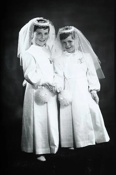 Two girls dressed for their first communion