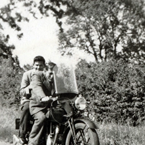 Two men on 1935 Velocette motorcycle