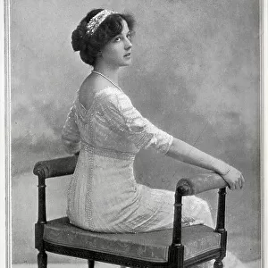 Olive May, actress and Gaiety Girl (1886-1947), formal studio portrait on boudoir chair. Olive Mary Meatyard married into the peerage twice, to Lord Victor Paget in 1913, then following their divorce, to the 10th Earl of Drogheda in 1922