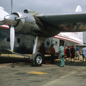 People boarding a small aeroplane