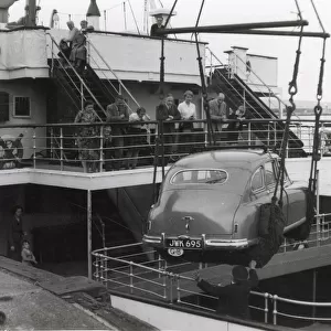 Shipping a British car by ferry, Fishguard, South Wales. Date: 1950s