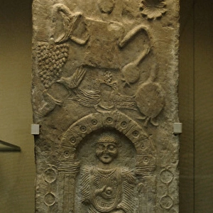 Stela relief depicting a male figure in a niche and a Tanit