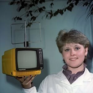 Woman holding a small television