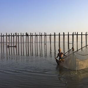 Man fishing with large net by U Beins Bridge, Taugthaman Lake, Amarapura
