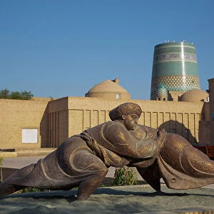 Sculpture with Kalta Minaret in the background, Ichon Qala (Itchan Kala), UNESCO World Heritage Site, Khiva, Uzbekistan, Central Asia, Asia