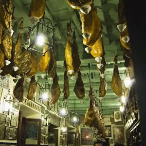 Tapas bar and restaurant with hams hanging from the ceiling