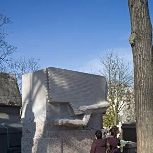 Visitors photograph the tomb of Oscar Wilde, Pere Lachaise cemetery, Paris