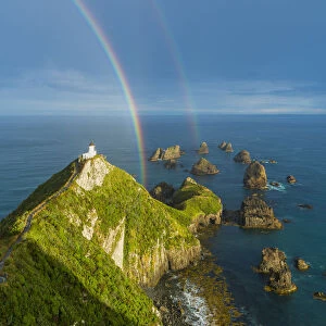 Double rainbow over Nugget Point lighthouse after the storm