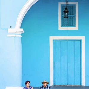 Two people sitting in Plaza Vieja (Old Town Square), Havana, Cuba