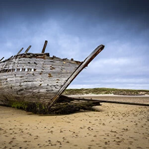 Shipwreck at low tide on Magheraclogher beach. An Bun Beag, Bunbeg, County Donegal