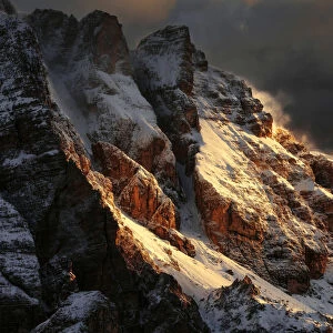 Snowy peaks of the Dolomites during a fiery sunrise from the Giau Pass, Dolomites, Italy