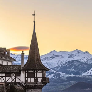 Sunrise at the castle of Oberhofen am Thunersee with the snow-covered Bernese Alps