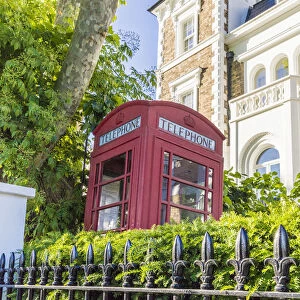 Telephone box in front garden, Notting Hill, London, England, UK