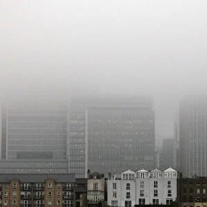 A low fog engulfs the skyscrapers of the financial district of Canary Wharf
