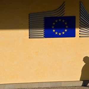 The shadow of a worker is seen beside the EU Commission building in Brussels, Belgium