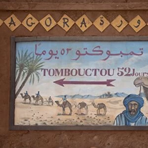 Tombouctou 52 days direction sign in desert town, Zagora, Sahara, Morocco, may