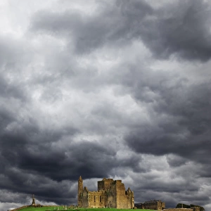 Europe, Ireland, County Tipperary. Lightning over ruins of the Rock of Cashel. Credit as