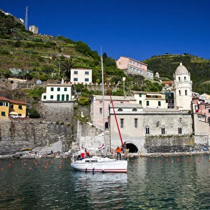 Europe; Italy; Vernazza; Sail Boat landing at the City and Church of Santa Margherita