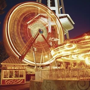 The Fun Forest at the Seattle Center with the Ferries Wheel and Merry-go-Round in motion