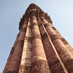 India, Delhi. Carved stone minaret at Qutub Minar