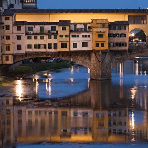 Italy, Tuscany, Florence, Ponte Vecchio reflected in Arno River at dusk