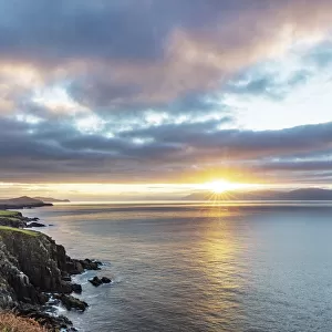 Sunrise over Dingle Bay as fishing boats heads out in County Kerry, Dingle, Ireland