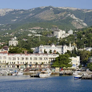 Ukraine, Yalta. Black Sea view of the port of Yalta with the Crimean Mountains in