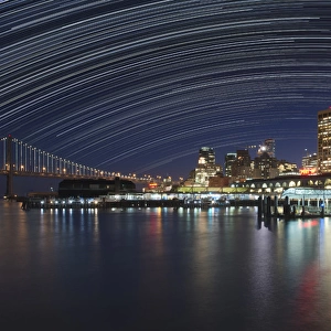 USA, California, San Francisco. Composite of star trails above downtown. Credit as