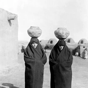 ZUNI WATER CARRIERS, c1903. Two Zuni women carrying pots of water on their heads