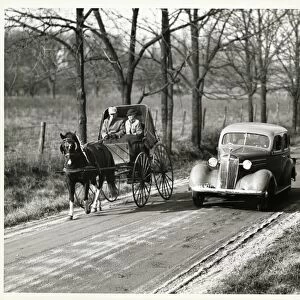 Car passing horse and carriage