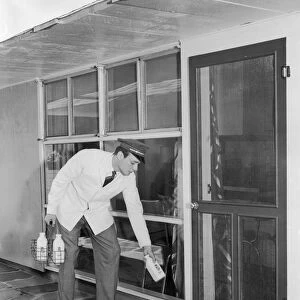 Milkman delivering milk door to door
