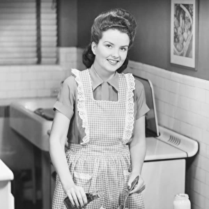 Woman preparing salad in kitchen, (B&W)