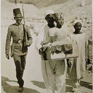 The mannequin or bust of Tutankhamun being carried from the tomb, Valley of the Kings, 1922 (gelatin silver print)