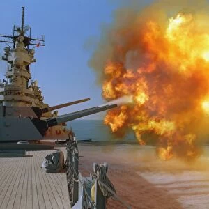 Battleship USS Wisconsin fires a round from one of the Mark 7 16-inch / 50-caliber guns