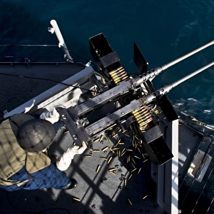 Seaman fires twin. 50 caliber machine guns aboard USS Boxer