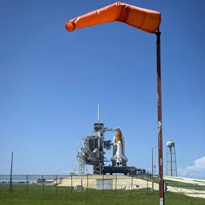 Space shuttle Endeavour is framed by a windsock at the launch pad at Kennedy Space Center
