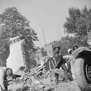 Loading debris from wrecked buildings along Independence Avenue, Washington, D. C, 1942. Creator: Gordon Parks