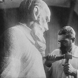 Russian sculptor Sergey Merkurov (1881-1952) working on his statue of Leo Tolstoy Artist: Anonymous