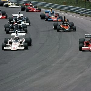 Mosport Park, Ontario, Canada. 20th June 1976: Brian Redman, Lola T332C, leads eventual winner, Alan Jones, Lola T332, Danny Ongais, Lola T332