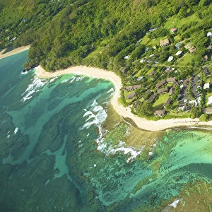 Aerial View Of Houses Along The Coast Of An Hawaiian Island; Na Pali Coast Of Kauai, Hawaii, United States Of America